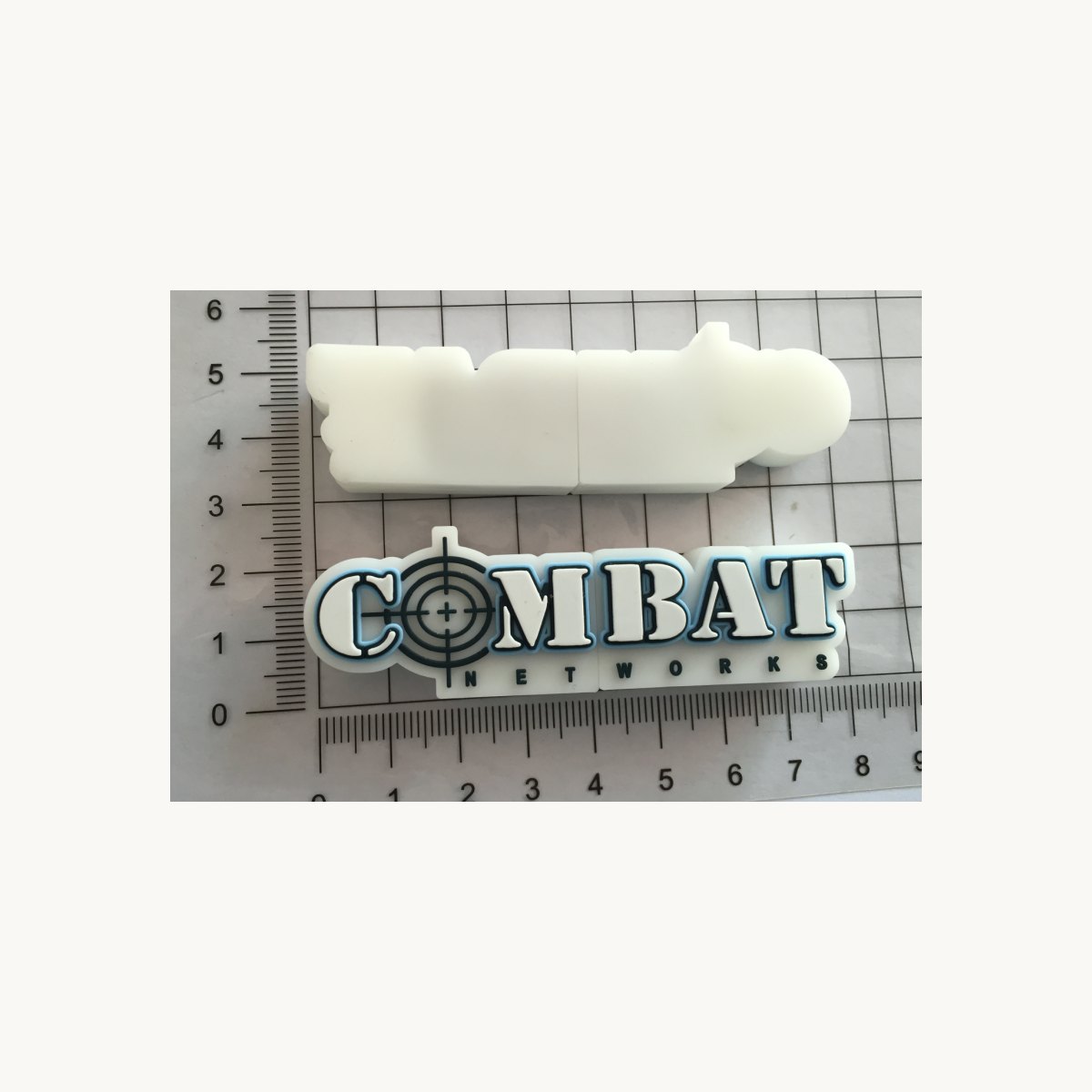 Moulded soft PVC badge next to a blank white moulded shape