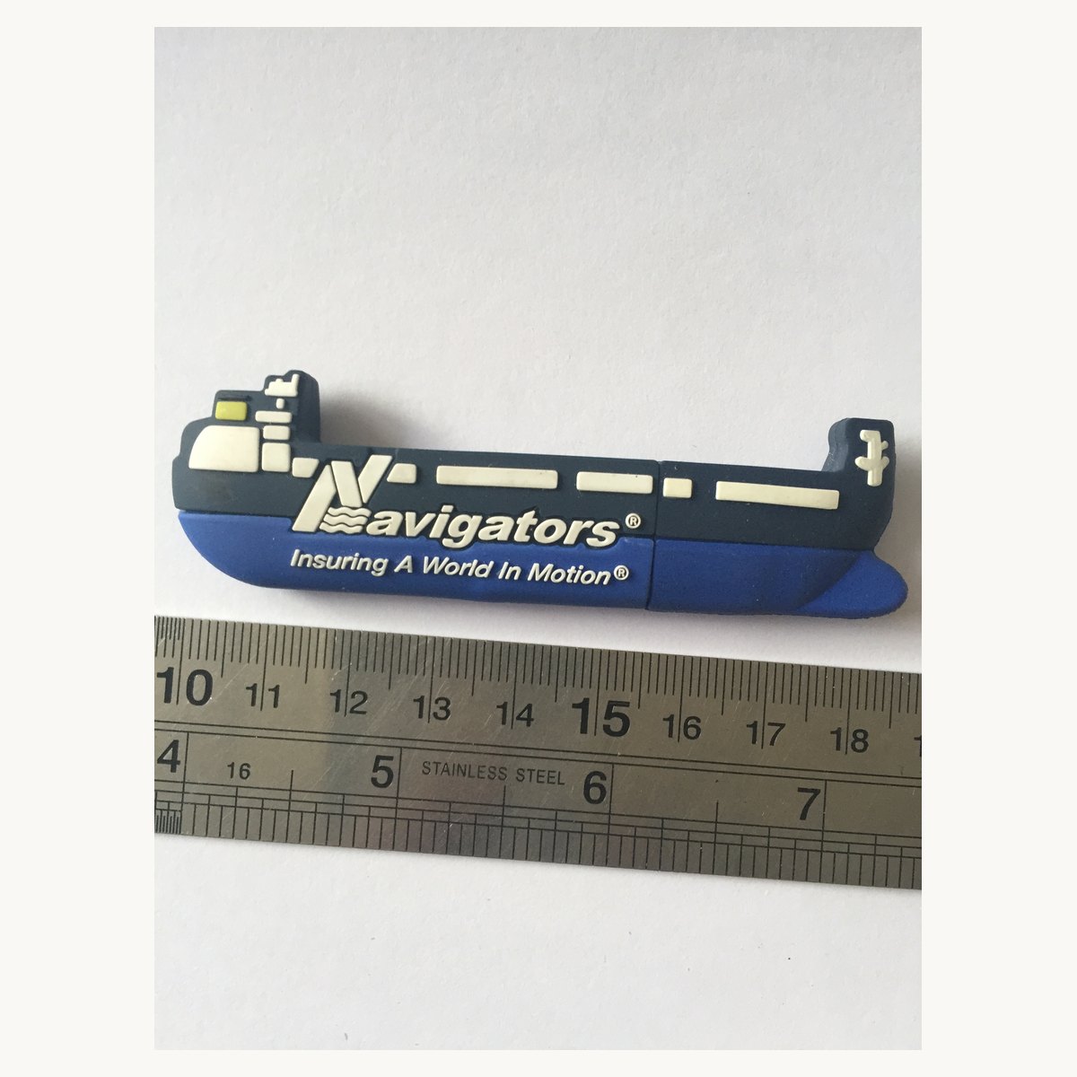 Soft PVC keychain moulded as a riverboat, photographed with a ruler for size