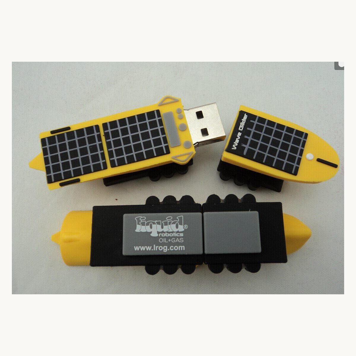 Yellow soft PVC USB casings moulded as solar panel shapes, front and back views