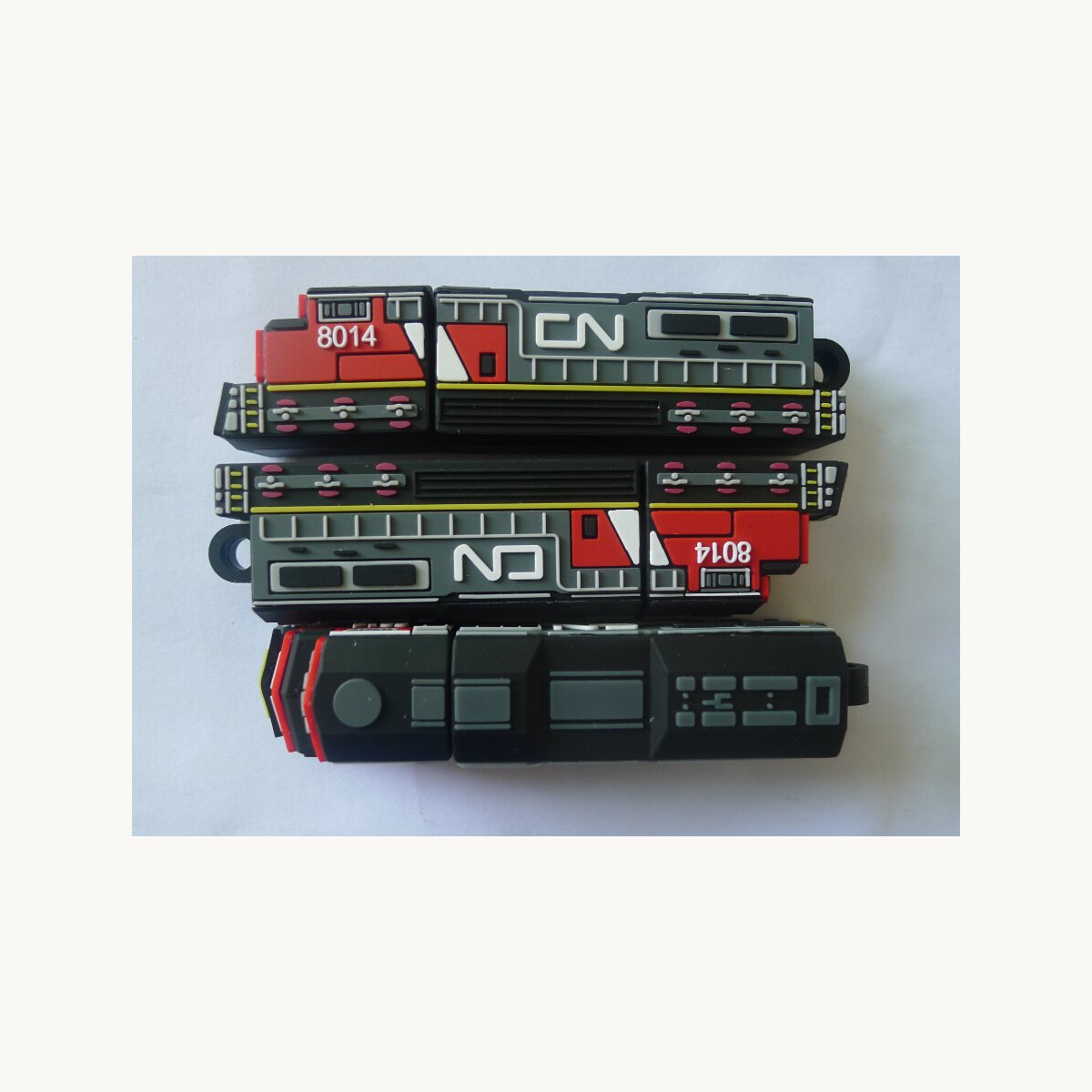 Soft PVC USB drive casings moulded as locomotive shapes, shown in four variants
