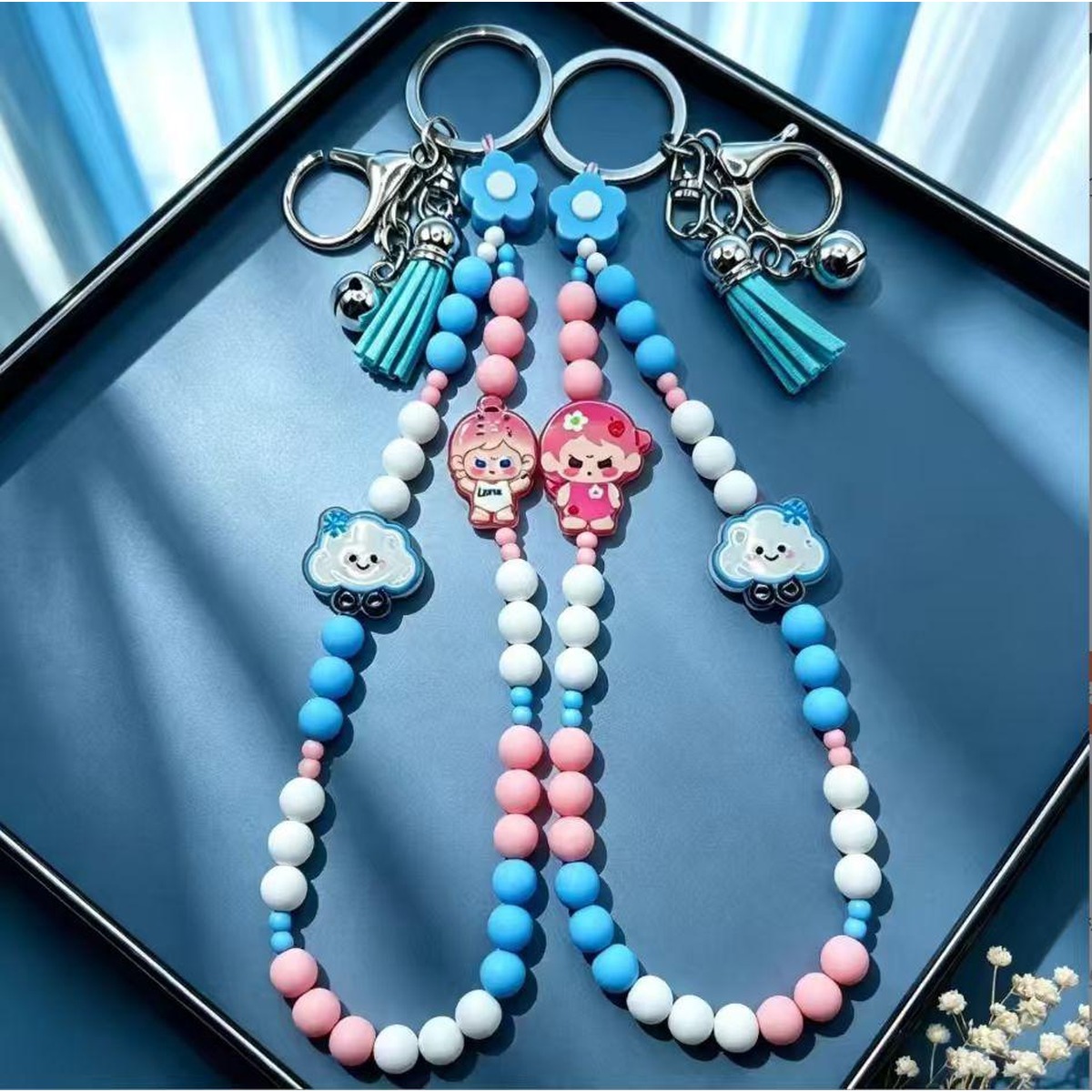 Damper bead charm worn as a phone wrist strap with a swivel hook