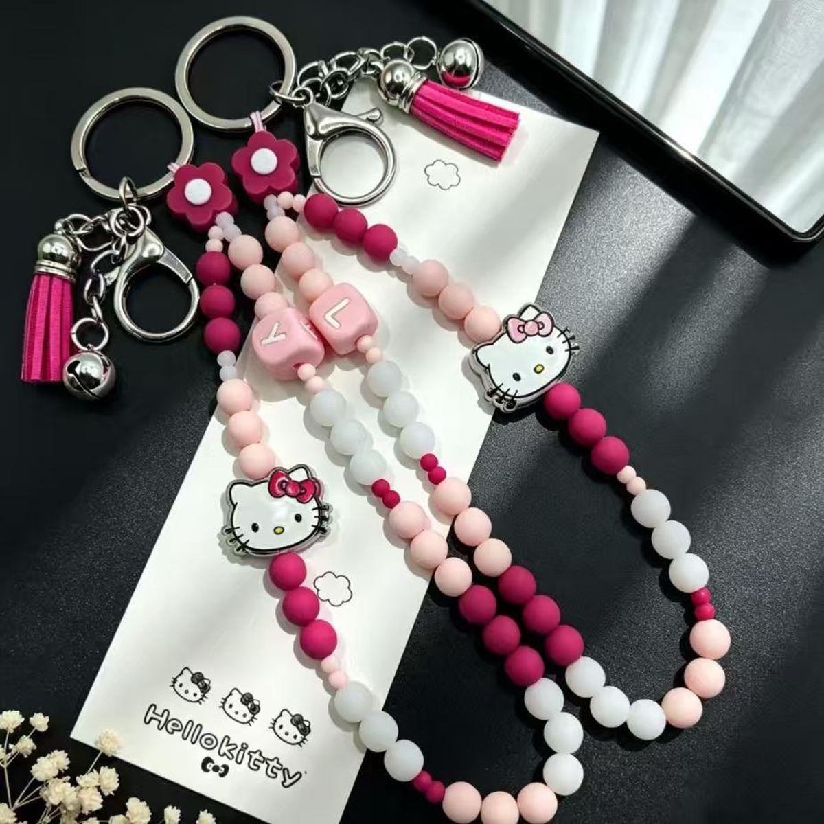 Damper bead charm fitted on a keyring and carried on a bag