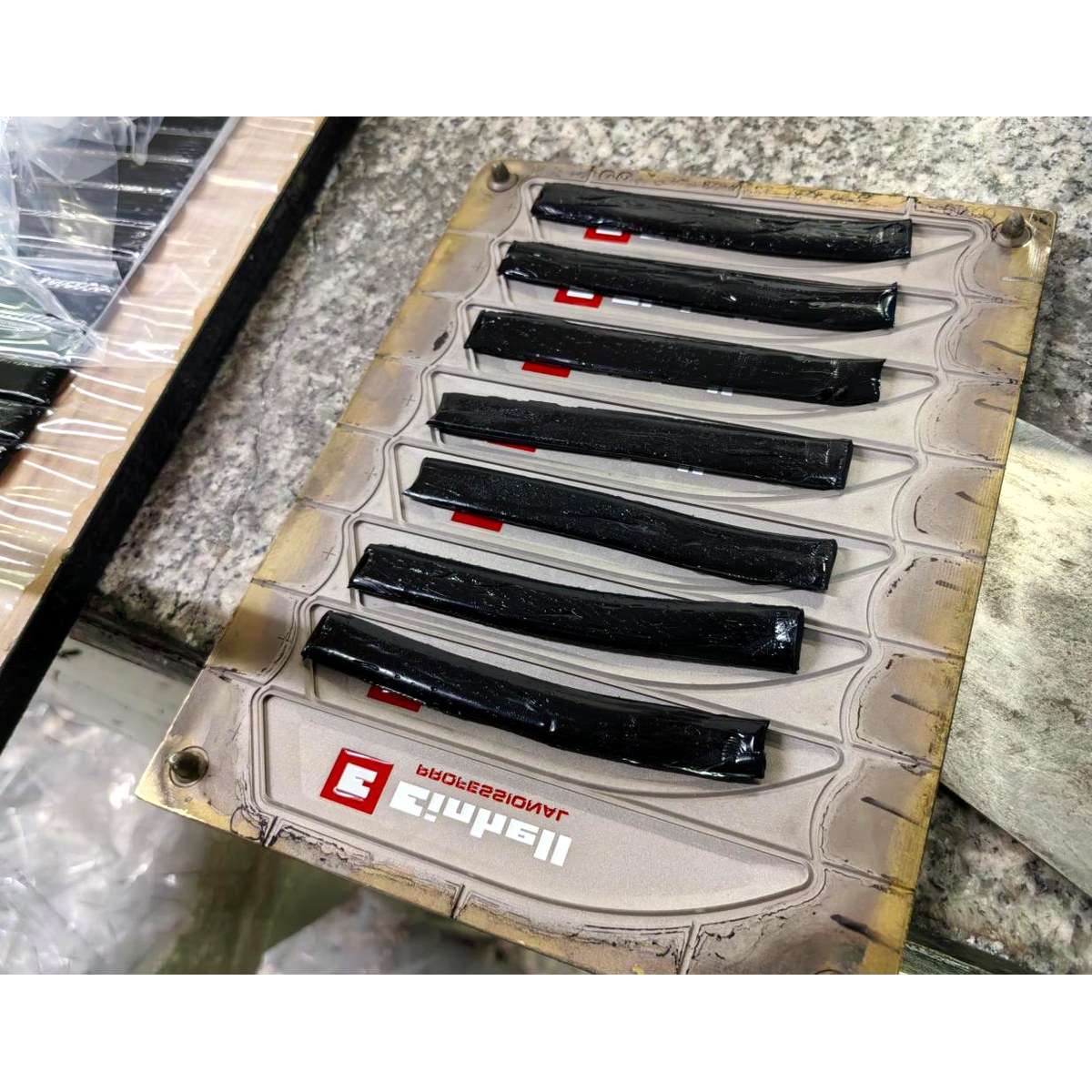 Compression moulding of silicone nameplates under heat and pressure